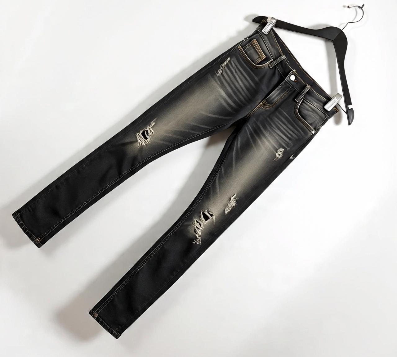 black_distressed_denim_jeans_displayed_on_a